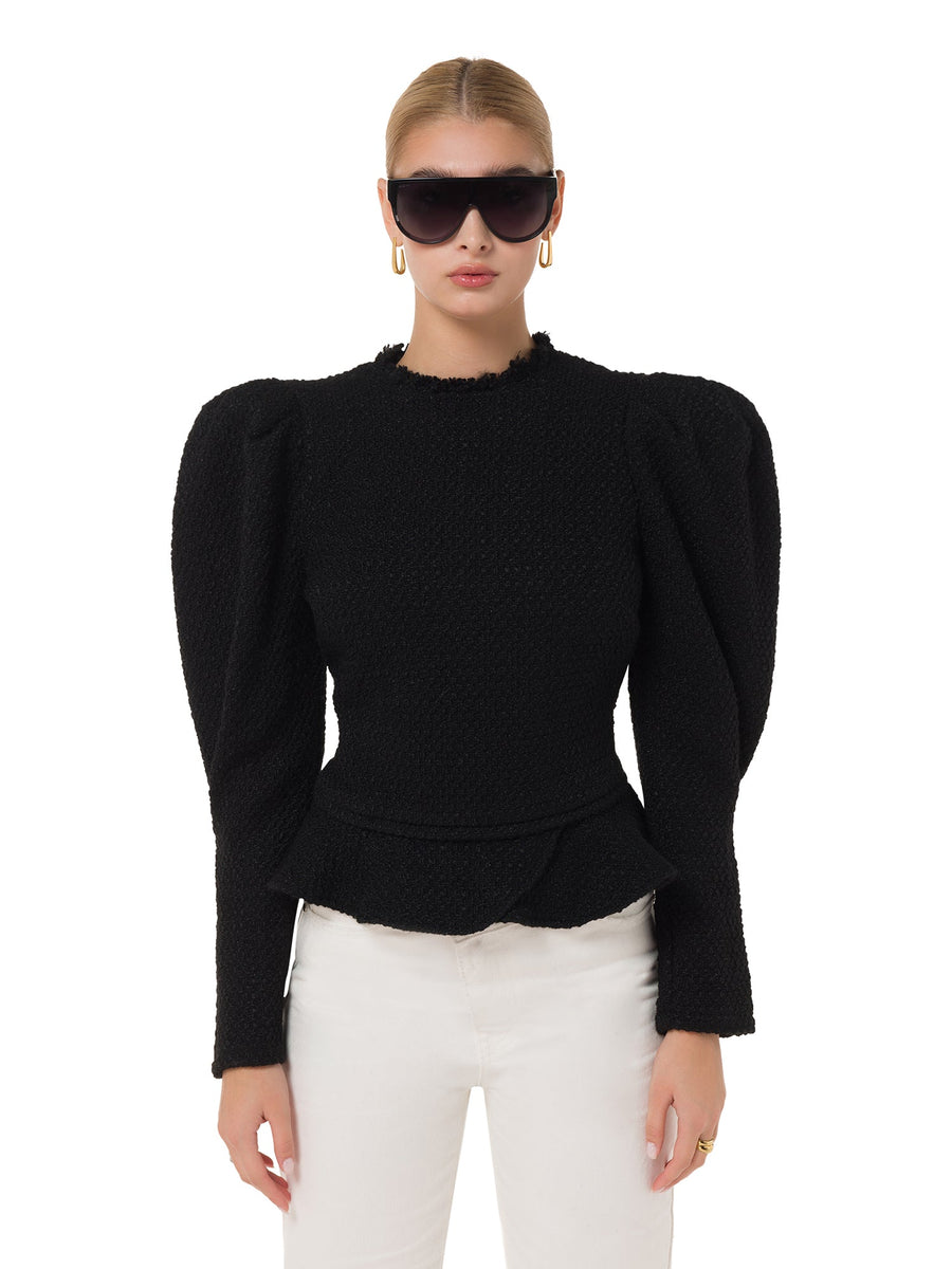 Styled sunglasses on model in black power suit – ALALYA GCC